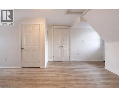 A room with two doors and a wooden floor.