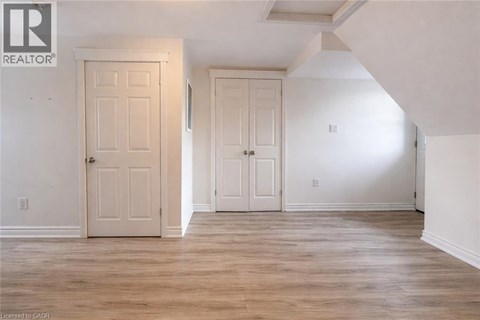 A room with two doors and a wooden floor.