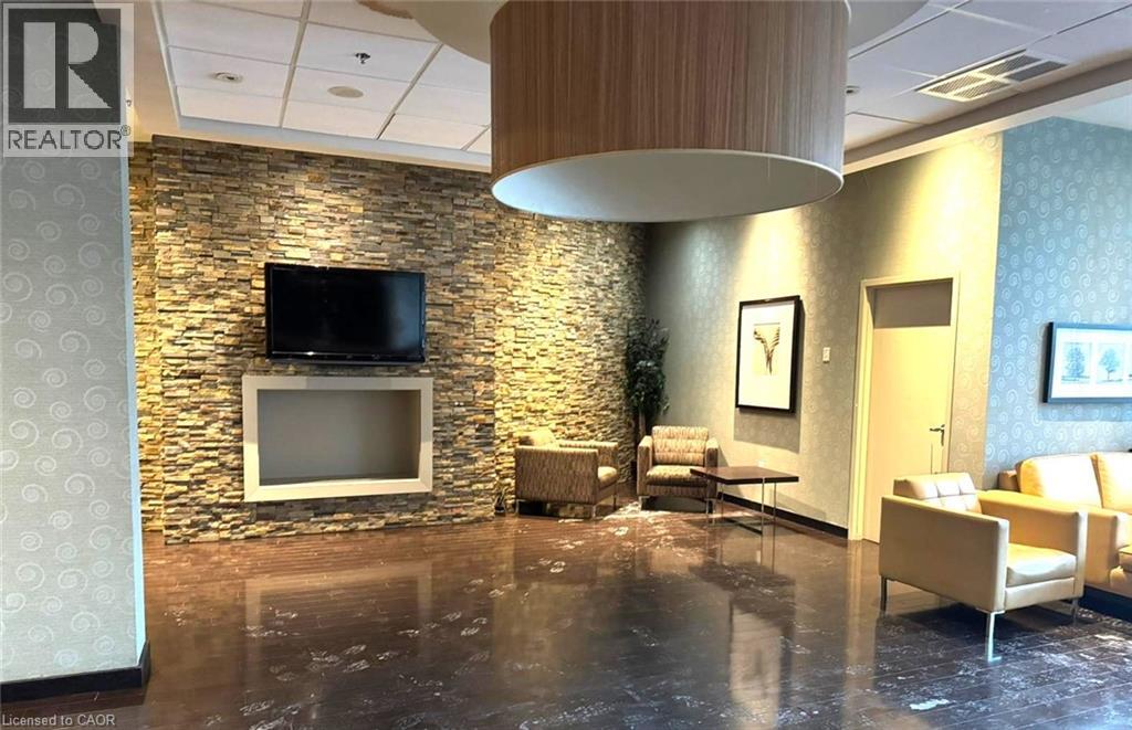A living room with a stone wall and a flat screen TV.