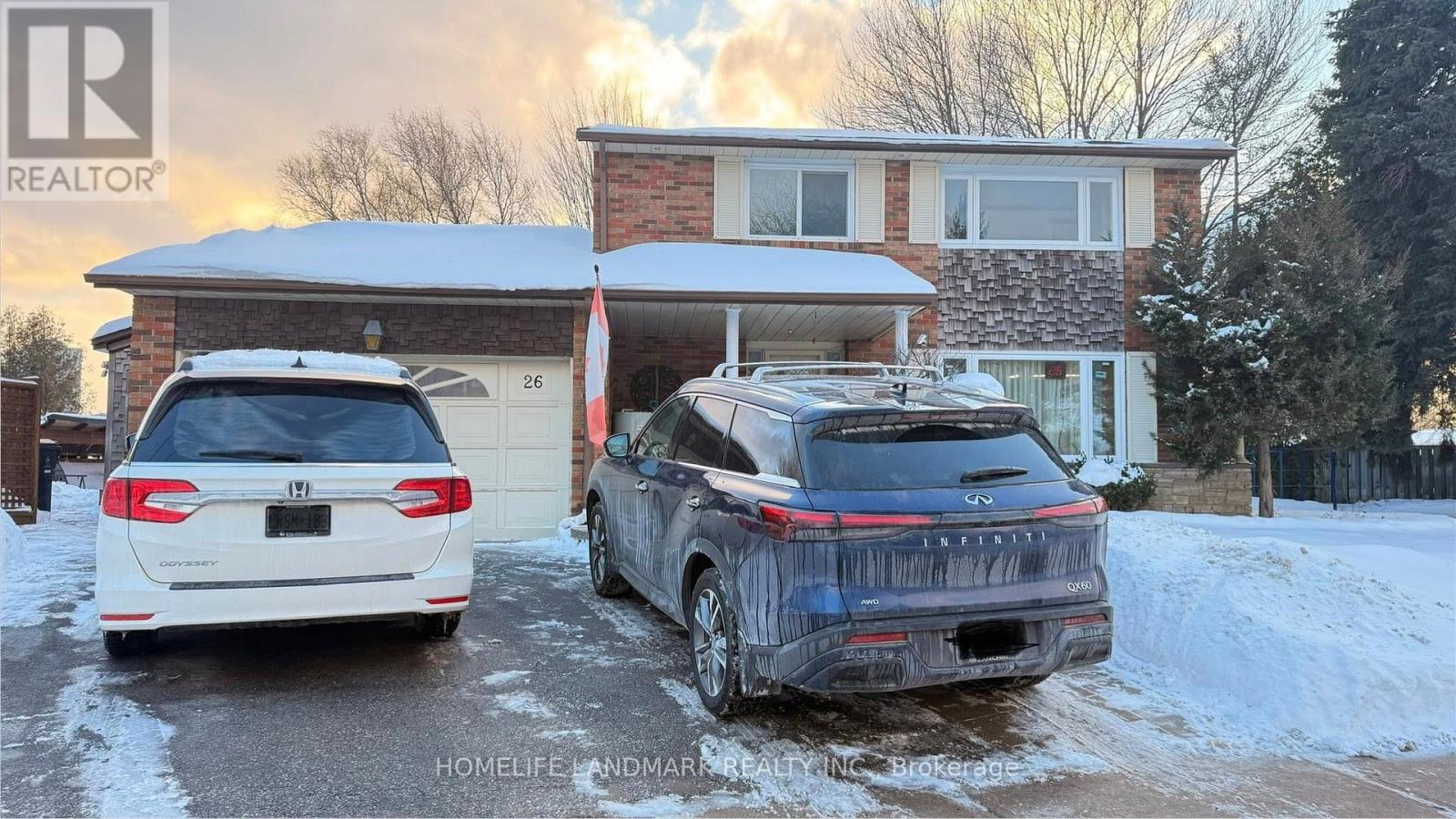 Two cars are parked in front of a house with snow on the ground.