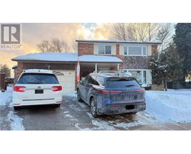 Two cars are parked in front of a house with snow on the ground.
