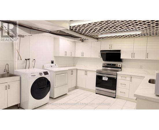 A modern kitchen with white appliances and cabinets.