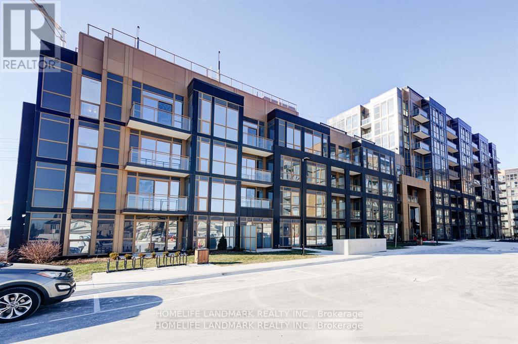 A modern building with a glass facade and a car parked in front.