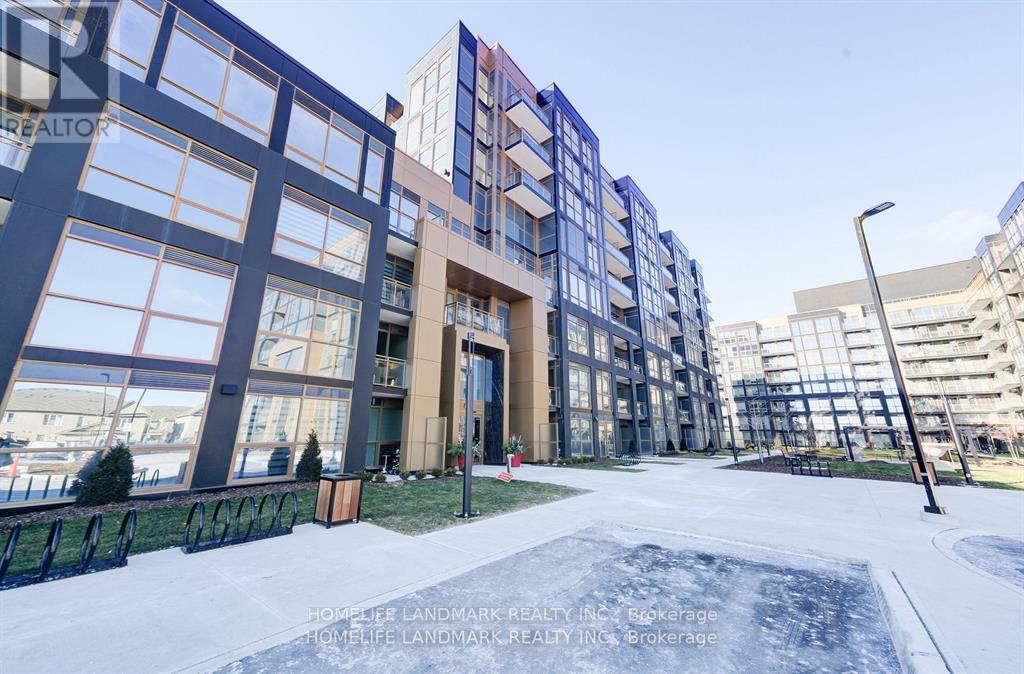 A modern building with glass windows and a sign that reads "HOME LANDMARK REALTY INC Brokerage".