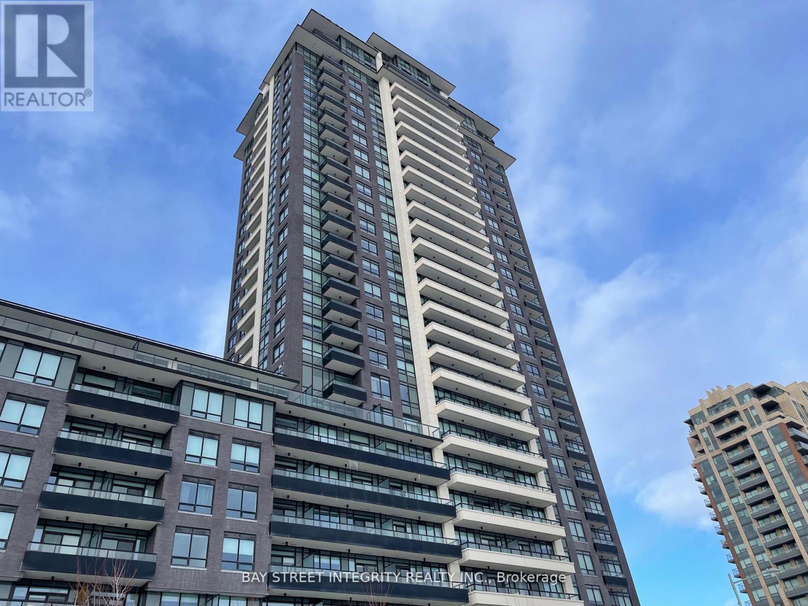 A tall building with the words "Bay Street Integrity Realty, Brokerage" on it.