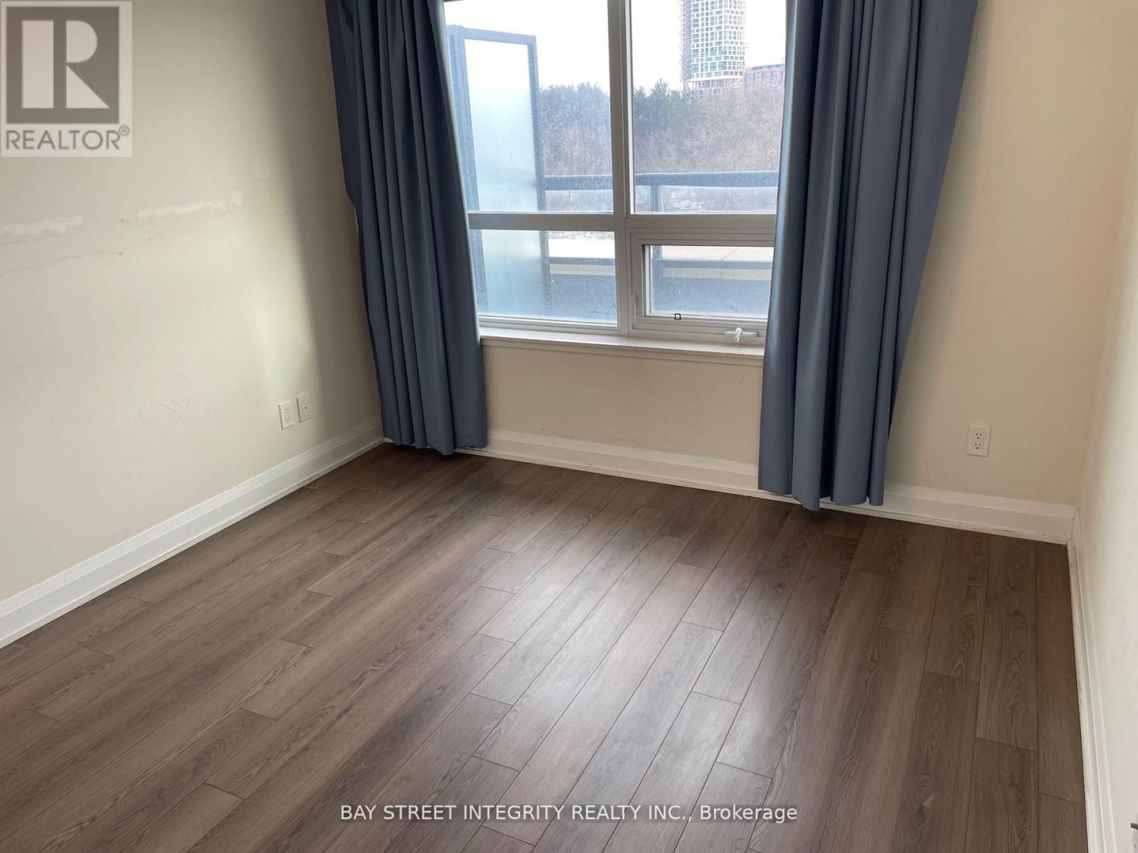 A room with a window and a view of a bridge.