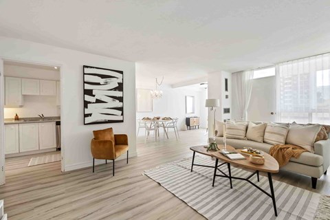 A modern living room with a large brown chair and a coffee table.