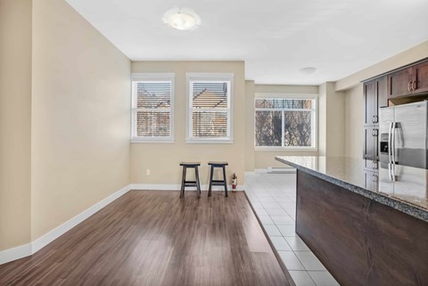 A kitchen with a bar stool and a counter.
