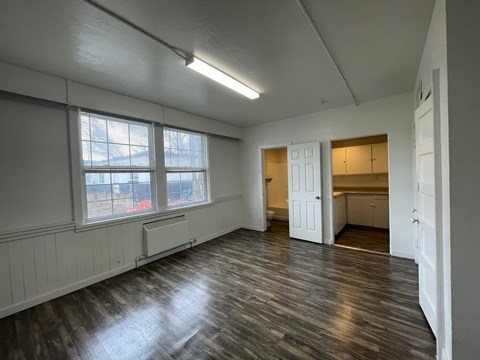 A room with wooden floors and white walls.