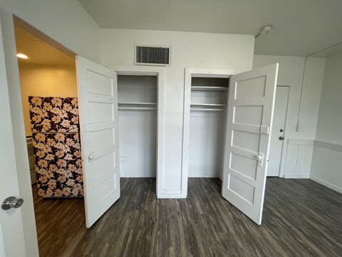 A room with two white doors and a wall-mounted air conditioner.
