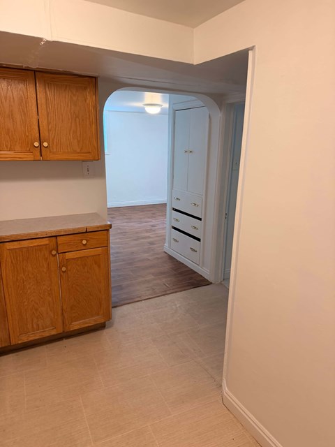 A kitchen with wooden cabinets and a white countertop.