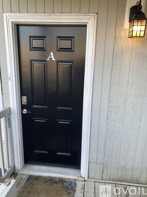A black door with a white frame and a white door handle.