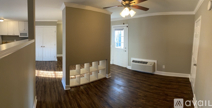 A spacious room with a ceiling fan and a window.