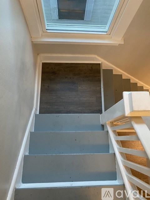A staircase with a skylight above it.
