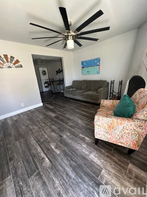 A living room with a ceiling fan and a couch.