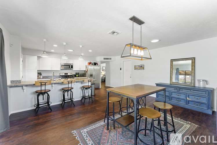 A kitchen with a bar area and a dining table.