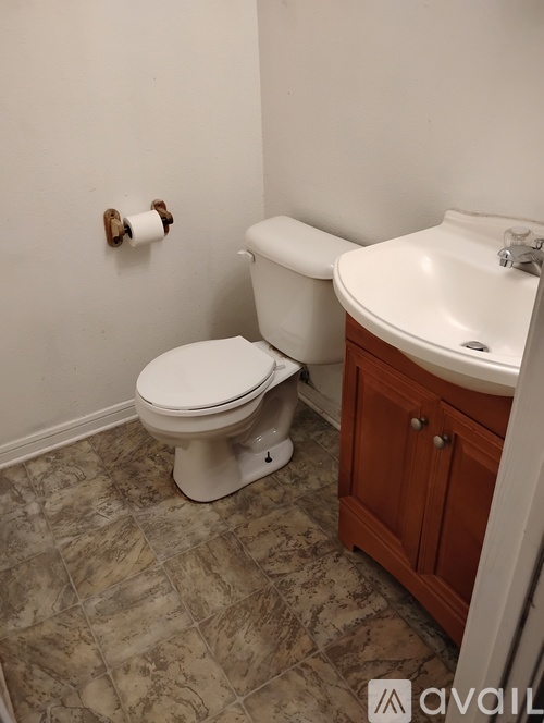 A white toilet sits next to a sink in a bathroom.