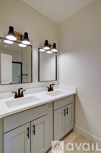 A bathroom with two sinks and two mirrors.