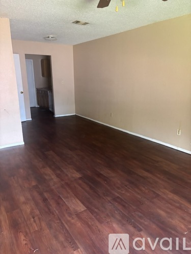 A room with wooden flooring and a white ceiling.
