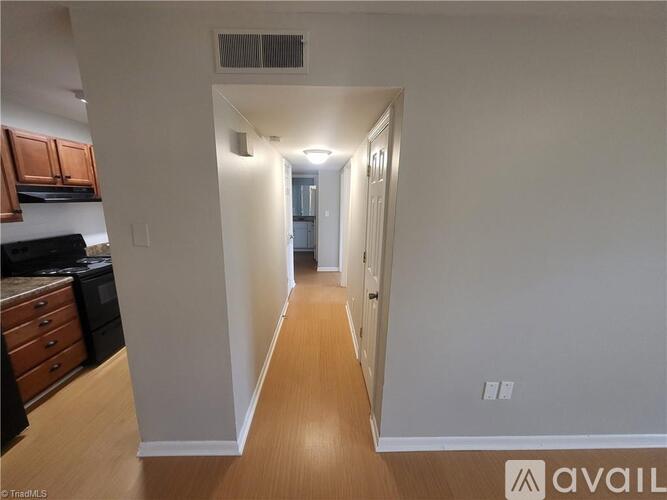 A long hallway with a door at the end.
