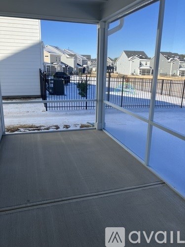 A view from inside a house looking out to a pool and other houses.