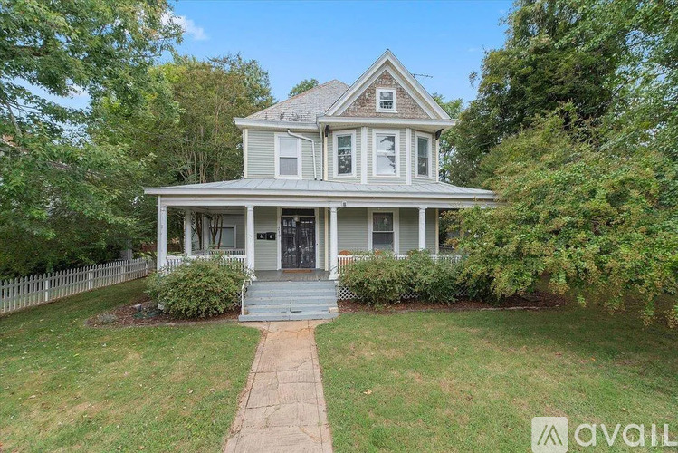 A house with a front yard and a walkway leading to the front door.