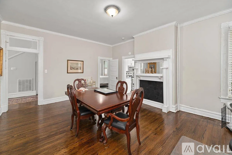 A dining room with a wooden table and chairs.