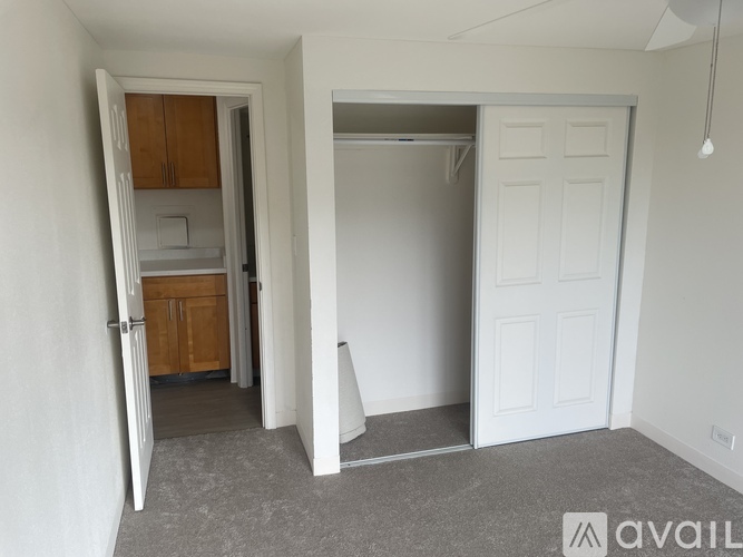 A room with a white door and a white wall.