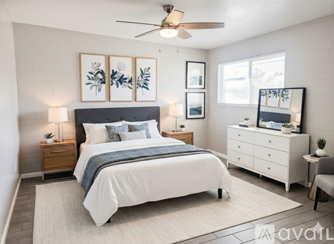 A bedroom with a large bed, a dresser, and a ceiling fan.