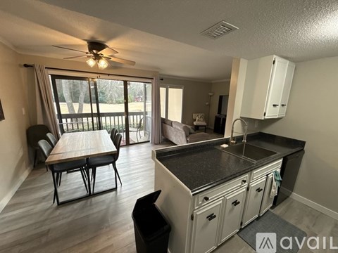 A kitchen with a table and chairs in front of a window.