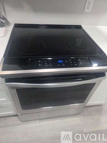 A black stove top oven with a digital display and control panel.
