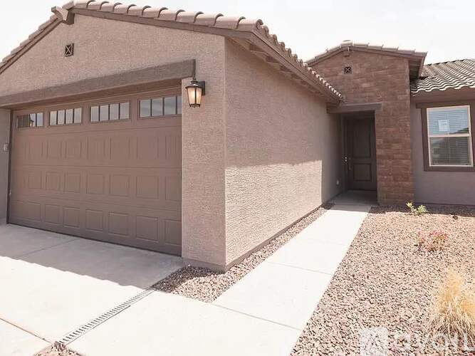 A house with a brown garage door and a brown roof.