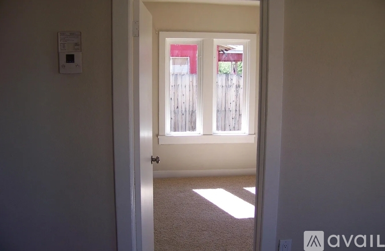 A room with a door leading to a balcony.