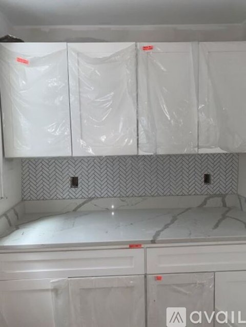 A kitchen countertop covered in plastic wrap.
