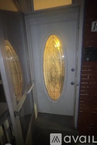 A white door with a glass window and a metal handle.