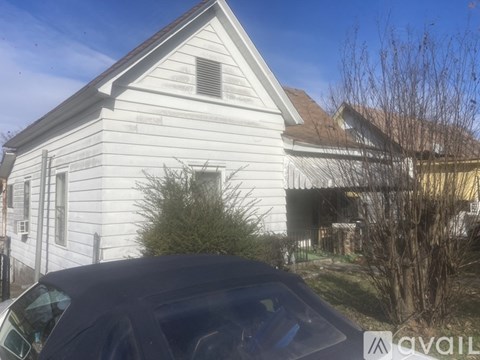 A house with a car parked in front of it.