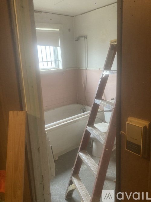 A bathroom with a ladder in it.