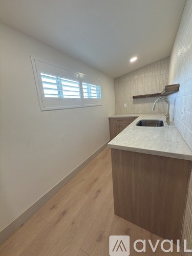 A kitchen with wooden cabinets and a marble countertop.