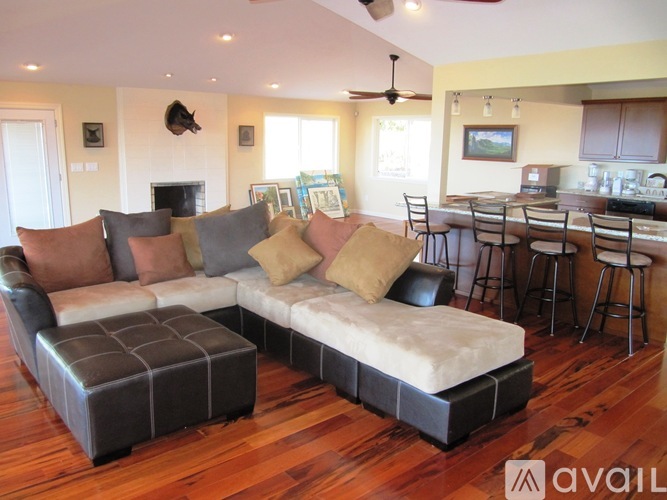 A living room with a couch and a fireplace.