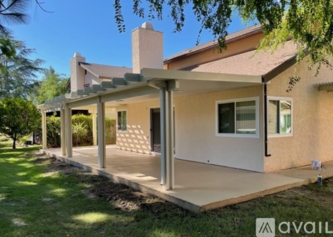 A house with a covered patio area is for sale.