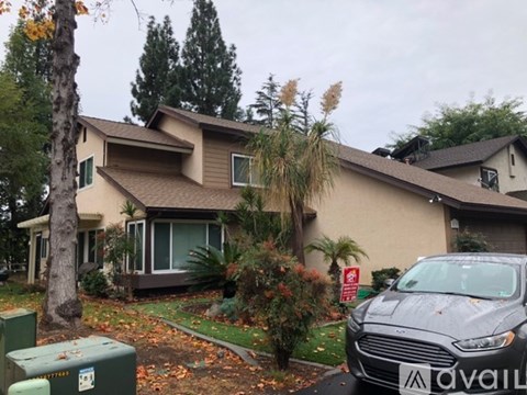 A house with a car parked in front of it.