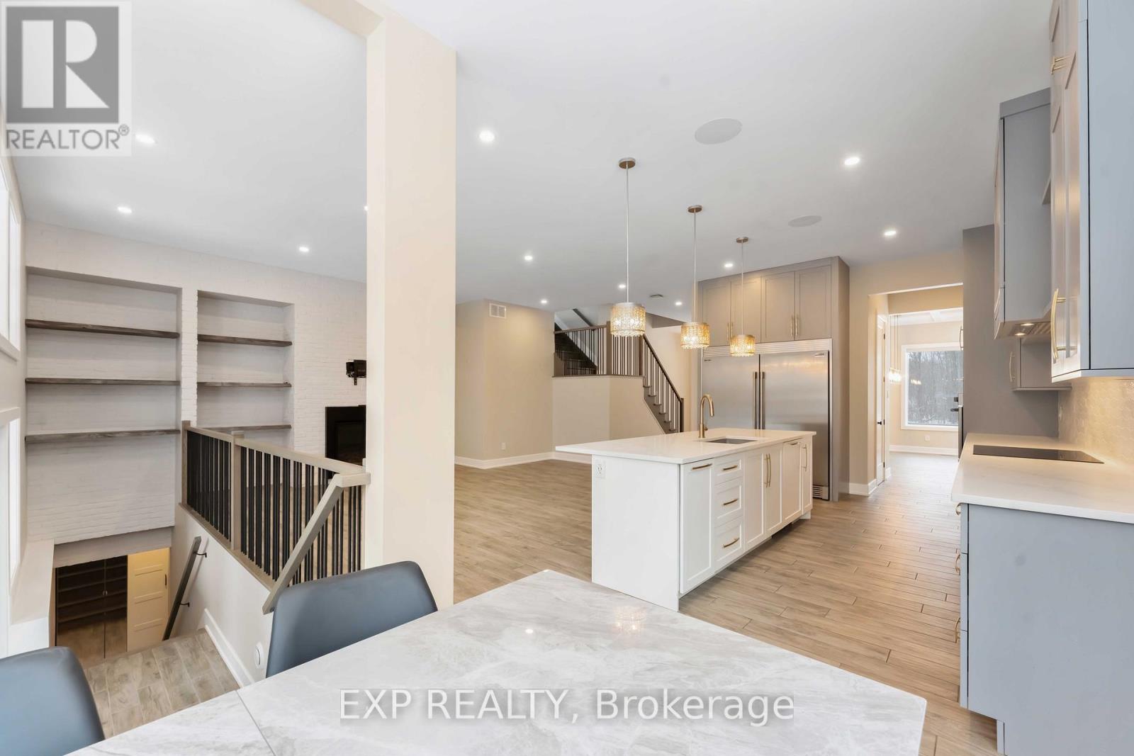 A modern kitchen with a dining table and chairs in the foreground.