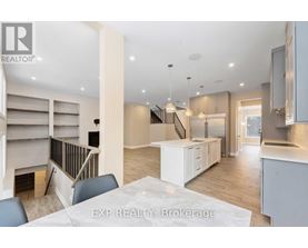 A modern kitchen with a dining table and chairs in the foreground.