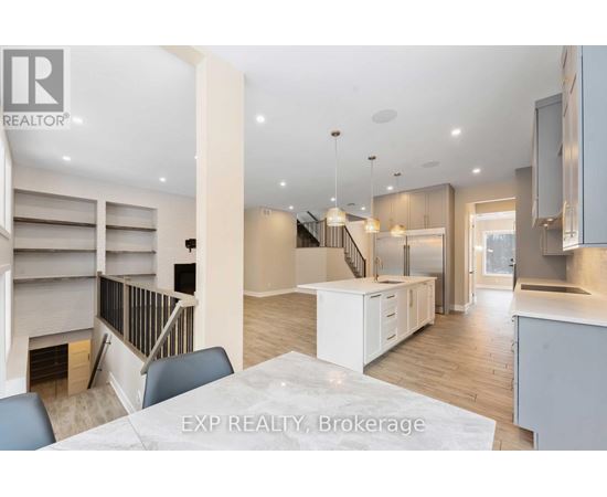 A modern kitchen with a dining table and chairs in the foreground.