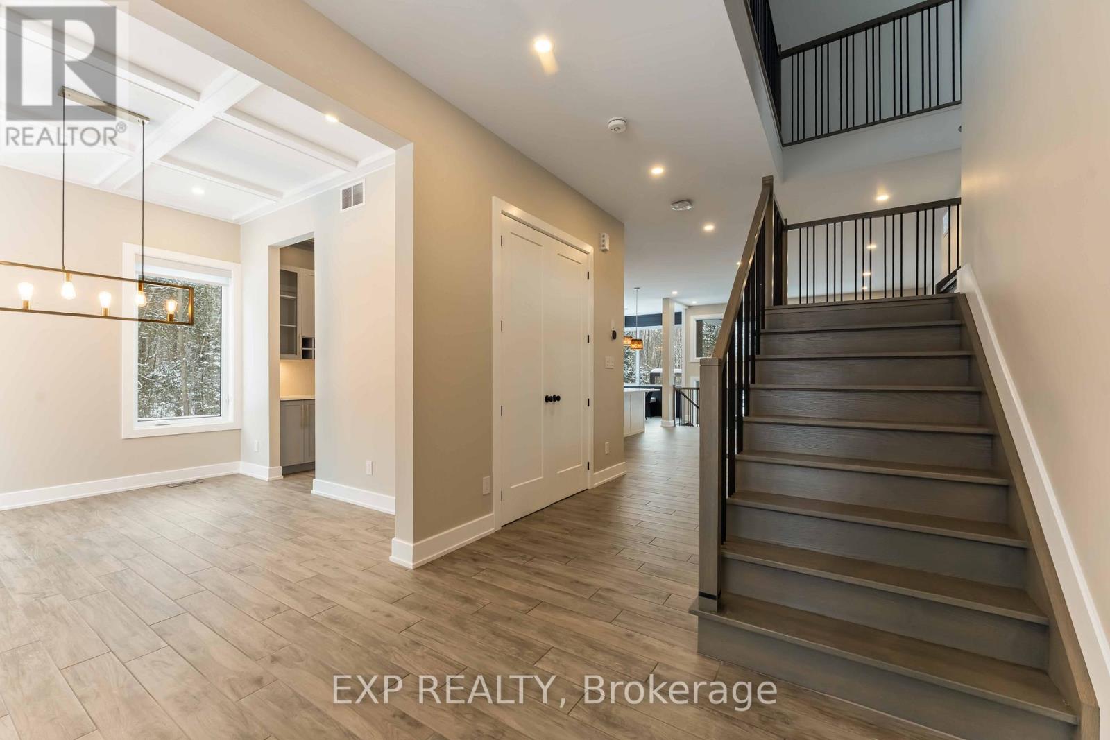 A spacious hallway with a staircase leading to the second floor.