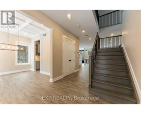 A spacious hallway with a staircase leading to the second floor.