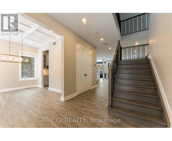 A spacious hallway with a staircase leading to the second floor.