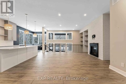 A spacious living room with a fireplace and a dining area with a table and chairs.