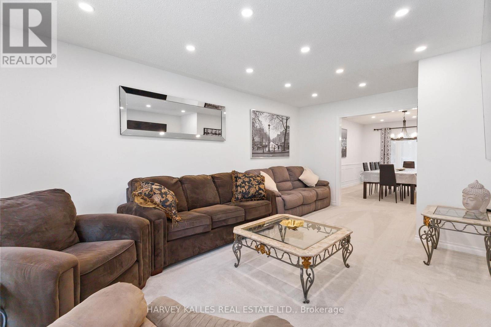 A living room with a brown couch and a coffee table.