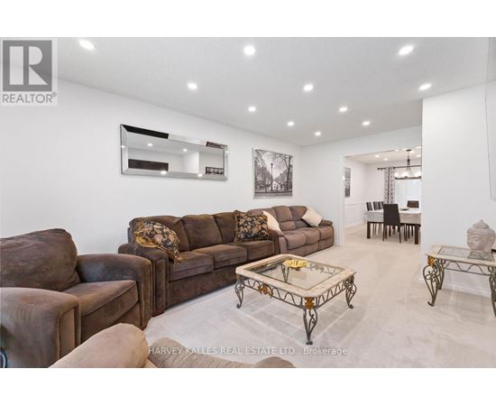 A living room with a brown couch and a coffee table.